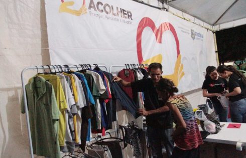 Rosimeire Gonçalves, 52 anos, paranaense de Maringá, escolhe uma peça de roupa na tenda do Projeto Acolher